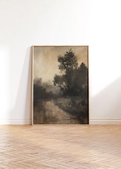 an empty room with a painting on the wall and hard wood flooring in front of it