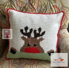 a crocheted reindeer pillow sitting on top of a chair