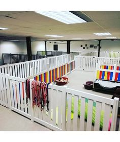 the room is filled with white railings and colorful bags on it's sides