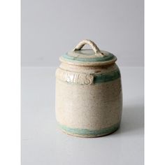 a white and blue ceramic jar sitting on top of a table