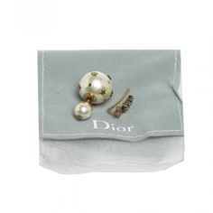 Brand New With Tag. Authentic. Comes With Pouch. These Asymmetric Earrings From Dior Brings The Label's Loved Tribales Design In A Refreshing Style. Sculpted From Aged Gold-Tone Metal, The Pair Flaunting One Earring Designed With Faux Pearls In The Characteristic Tribales Shape Accented With Star Motifs And The Other Earring Exhibits A Shooting Star Silhouette. Be Sure To Try Them With Everyday Outfits For A Touch Unique Style. Includes Original Dustbag Material: Resin Beads, Crystals Earrings Width Diameter- 1.6 Cm Metal Aged Gold Tone Finish Designer White Earrings For Formal Occasions, Designer White Earrings For Evening, Luxury White Earrings For Evening, Luxury White Evening Earrings, White Brooch Jewelry For Evening, White Evening Jewelry With Brooch, Rhinestone Mirror, Asymmetric Earrings, Star Silhouette