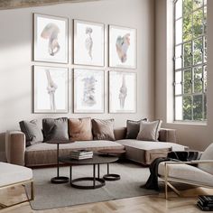 a living room filled with furniture and pictures on the wall above it's coffee table