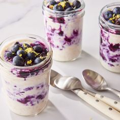 two jars filled with blueberries and yogurt