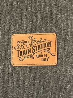 a patch that says, could be a train station kind of day on the back of a sweater