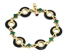 "This is a lovely bracelet is crafted from 14k yellow gold with a polished finish featuring circle links carved from black onyx with yellow gold ring inside each onyx circle, they alternate with s small diamond shape green onyx mounted in solid yellow gold frame. The bracelet has a bar release and fit clasp. It has the 14k gold content stamp. Hallmark: 14k MG Gemstone: green and black onyx Material: 14k rose gold Material: 14k yellow gold Measurement: 7.5\" long x 0.65\" wide x 0.13\" high Weigh Gold Onyx Bracelet For Formal Occasions, Polished Green Jewelry For Evening, Green Polished Jewelry For Evening, Green Polished Evening Jewelry, Green Polished Finish Evening Jewelry, Formal Black 14k Gold Bracelets, Evening Onyx Jewelry In Yellow Gold, Evening Yellow Gold Onyx Jewelry, Elegant Green Jewelry With Black Enamel