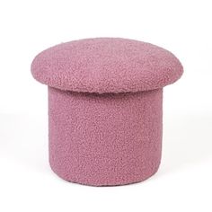 a small pink ottoman sitting on top of a white floor