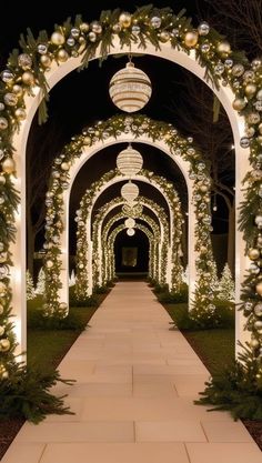 an archway decorated with christmas lights and greenery at the entrance to a formal wedding venue