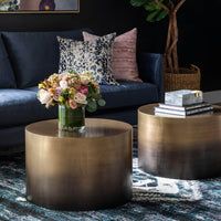 a living room filled with furniture and flowers on top of it's coffee table