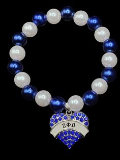 SORORITY JEWELRY-Blue and white rhinestone bracelet with Finer 1920 heart charm White Bling Bracelets For Anniversary, White Bling Round Beads Jewelry, Heart-shaped Rhinestone Bracelet As Gift, White Bling Bracelet, White Jewelry With Heart Charm And Round Beads, White Round Beads Jewelry With Heart Charm, White Charm Bracelet For Anniversary, White Charms Bracelet For Anniversary, White Charms Bracelets For Anniversary