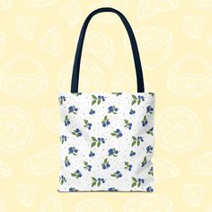 This Maine blueberry tote bag comes in 2 sizes, is lightweight, and has a cute design. It is perfect for carrying essentials while adding a touch of style. Ideal for those who love nature-inspired designs and want a durable tote for everyday use. Great for picnics, grocery shopping, or as a beach bag. Product features - 100% Polyester body: Extremely strong and durable fabric - Seamless thread color for a polished look - Reinforced stitching on handles for added strength - Boxed corners for extra room and stability - Available in 5 handle colors and 3 sizes to match different needs Care instructions - Remove all items from the bag before cleaning. Suggested to pretreat visible stains with stain remover. Mix warm water with laundry detergent and clean the bag with terry washcloth or a soft Blue Reusable Tote Shoulder Bag, Eco-friendly Blue Tote Bag, Blue Reusable Shoulder Bag For Everyday Use, Blue Reusable Shoulder Bag For Daily Use, Casual Blue Canvas Bag Gift, Blue Summer Canvas Bag For Everyday Use, Blue Summer Bag As Gift, Blue Summer Bag For Gift, Blue Summer Style Bag As Gift