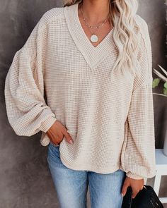 Long Sleeve Knit V-neck Sweater For Loungewear, Beige Waffle Knit Long Sleeve Sweater, Cozy Waffle Knit Long Sleeve Sweater, Cozy Long Sleeve Waffle Knit Sweater, Waffle Knit V-neck Sweater In Loose Fit, Oversized Waffle Knit Tops For Fall, Beige Waffle Knit Long Sleeve Top, Beige Waffle Knit Sweater For Winter, Beige Long Sleeve Waffle Knit Top