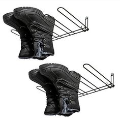 two pairs of black shoes are hanging on a rack with shoelaces attached to them