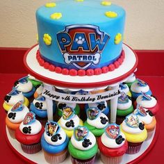 a paw patrol themed birthday cake with cupcakes