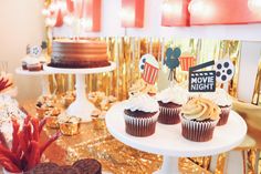 a table topped with lots of cupcakes and cakes