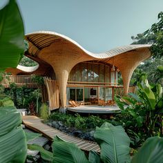 a house made out of bamboo and surrounded by greenery