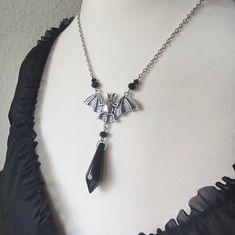 Beautiful gothic bat necklace with a black crystal and black beads. Length of chain: approx. 19.5 inch, adjustable Pendant length: approx. 3.2 inch Pendant width: approx. 2 inch Material: silver-plated metal, glass, acrylic Lead and nickel free I add a polishing cloth to every order to remove dirt, stains or any discoloration from your piece of jewelry. Each piece of jewelry is sent lovingly and beautifully packaged. Bat Necklace, Black Pearls, Dirt Stains, Witchy Jewelry, Gothic Jewelry, Black Crystals, Black Pearl, Black Beads, Making Ideas