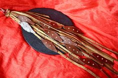 a black hat with brown feathers on it