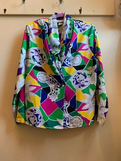 "This blouse is for someone who like to have fun with their wardrobe. Isn't afraid to add more than a few splashes of colour and a cool retro vibe. It's a deep V blouse with hidden buttons. Would look awesome tucked into high waisted pants or pencil skirt but also try it over leggings and ankle boots. Size on tag says 14 please see measurements. In very good preowned condition and Made in the USA.  \"pit to pit\" measurement 20.5\" Shoulders 17\" (has shoulder pads that you could remove) Length 23\" V3" Deep V Blouse, Colourful Blouse, California Retro, Colorful Blouses, Stacked Bangles, Retro Vibe, High Waisted Pants, Deep V, Have Fun