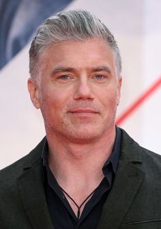 a man with grey hair and black shirt