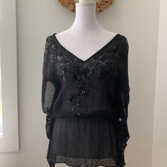 Nwot Vintage Bebe Black Sheer Shirt Size S. Never Worn. 100% Silk With Beautiful Beading. Original Extra Beads Included. It Was Too Long For Me To Ever Wear! You Will Need A Cami Underneath And It Is Better For Ladies That Are A True S Or Xs. Black Sequined Summer Blouse, Bohemian Short Sleeve Tops For Party, Beaded Tops For Night Out In Spring, Bohemian Short Sleeve Party Tops, Chic Short Sleeve Embellished Blouse, Elegant Beaded Short Sleeve Tops, Elegant Beaded Tops For Night Out, Embellished Short Sleeve Tops For Night Out, Black Bohemian Top With Sequins