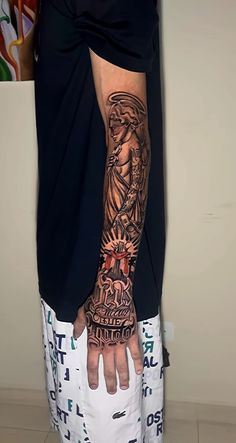 a man's arm with tattoos on it