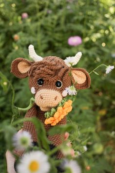 a crocheted cow with flowers in its mouth and the caption says, bayatan the bull calf