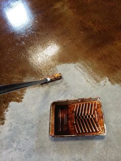 a dirty floor with a broken toothbrush on it