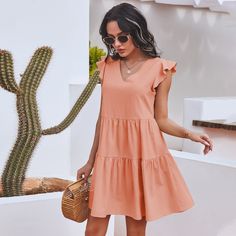 The EMES SHOP dress is detailed with gorgeous ruffle sleeves. Features a v neck line. shift dress silhouette. tiers. and an above knee length. Pair it with a hat and espadrilles for a refreshing summer look.MATERIAL:100% Soft Cotton MEASUREMENTS:Dress Length is 35-37"in Small | Bust & Waist: 37"-39"in Medium | Bust& Waist: 39"-41"in Large | Bust& Waist: 41"-43in V-neck Tiered Dress With Ruffle Hem For Vacation, Feminine V-neck Tiered Summer Dress, V-neck Tiered Dress With Ruffle Hem For Day Out, V-neck Tiered Dress With Ruffle Hem For Beach, Summer Tiered Short Sleeve Dress With Ruffle Hem, Summer Tiered Dress With Ruffle Hem And Short Sleeves, Vacation Tiered Dress With Ruffle Hem And Flutter Sleeves, Casual V-neck Tiered Dress For Beach, Short Sleeve Tiered Dress With Ruffle Hem For Beach