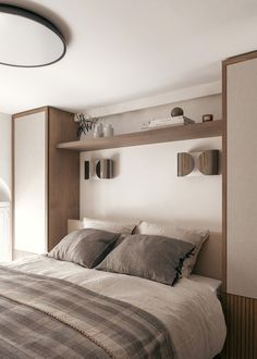 a bedroom with a bed and shelves on the wall next to it's headboard