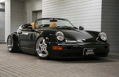 a black sports car parked in front of a building