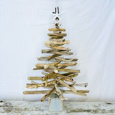 a wooden christmas tree made out of driftwood