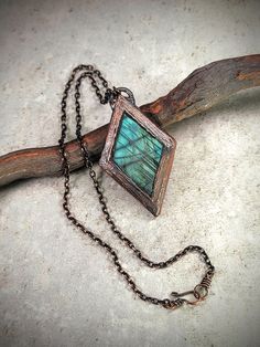 Discover the magic of shifting hues with our Green and Blue Labradorite Diamond-Shaped Copper Electroformed Necklace. This mesmerizing piece captures the enchanting play of light, with a labradorite gemstone that dramatically changes colors from vibrant green to deep blue as you move. Handcrafted in copper, this necklace is a stunning symbol of transformation and protection, reflecting the beauty of the ever-changing world around you. Perfect for adding an element of surprise and elegance to any outfit, this one-of-a-kind piece will captivate and inspire with every glance. Complimentary gift wrapping included Nature-inspired Labradorite Jewelry For Healing, Nature-inspired Labradorite Healing Jewelry, Nature-inspired Healing Labradorite Jewelry, Mystical Labradorite Pendant Jewelry, Electroformed Labradorite Necklaces For Healing, Soldered Labradorite Jewelry For Jewelry Making, Mystical Blue Labradorite Jewelry, Spiritual Labradorite Jewelry With Natural Inclusions, Turquoise Labradorite Pendant Necklace