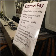 a sign that says express pay on the side of a table in front of a mirror