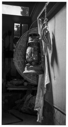 there are many suitcases hanging on the wall in this black and white photo,