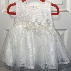 Darling Pretty White Dress For A Babygirl! Ordered For A Wedding But My Daughter Didn't End Up Wearing It. It Has Tulle And Lace And A Pretty Embroidered Floral Accent In The Front. Also Has A Bow In Back. Condition: New Excellent Condition, With Tags. Size: Eu Size 80 Or Size 9-12m White Lace Trim Tutu Dress For First Communion, White Tutu Dress With Lace Trim For First Communion, Sleeveless White Lace Baptism Dress, Baptism Tutu Dress With Lace Bodice, Sleeveless Lace Baptism Dress For First Communion, Sleeveless Lace Baptism Dress, White Sleeveless Lace Baptism Dress, Sleeveless Lace Bodice Dress For Baptism, Sleeveless Lace Dress With Lace Bodice For Baptism