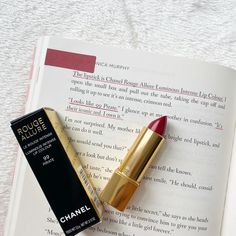 a book with a red post it flag on it. a quote underlined in red ink. a Chanel lipstick opened and the Chanel lipstick box next to it Million Kisses In Your Lifetime Aesthetic, One Million Kisses In Your Lifetime, A Million Kisses In Your Lifetime Quotes, Channel Lipstick, Kiss Stories