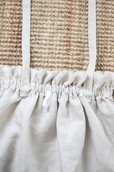 the back end of a white bag on top of a rug