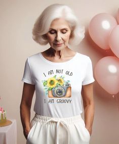 Celebrate a special occassion with our Tshirt, for any birthday girl!   This stylish tee features a delightful boho design, making it an ideal gift for her 40, 50, 60th birthday or any year. Crafted for comfort and flair, it's a must-have addition to any woman's wardrobe, ensuring she stands out on her special day. Treat her to a memorable birthday gift that combines nostalgia with trendy style!  * YOU HAVE A CHOICE BETWEEN TWO T-SHIRT STYLES: Measurments are in Centemeters and you can see them Summer Anniversary Graphic Print Tops, Summer Birthday Gift T-shirt With Short Sleeves, White Tops For Birthday Gift In Summer, White Top For Summer Birthday Gift, Summer Cotton Tops For Anniversary, Cotton Tops For Summer Anniversary, Cotton Tops For Anniversary In Summer, Summer Crew Neck Top For Birthday Gift, Crew Neck T-shirt For Anniversary In Summer