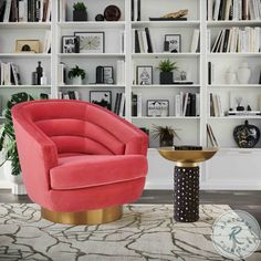 a pink chair sitting in front of a book shelf filled with lots of books on it