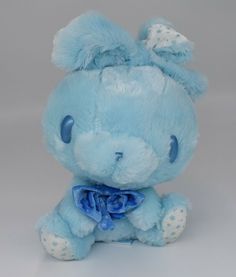 a blue teddy bear with a bow on its head