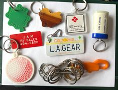 various keychains and magnets are laid out on a piece of paper