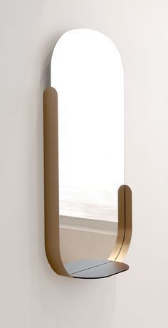 a mirror mounted to the side of a wall