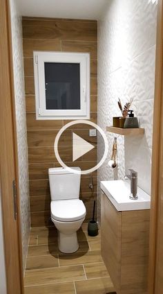 a white toilet sitting in a bathroom next to a sink