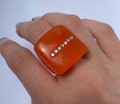 These beautiful colourful chunky rings are made from resin and are each hand made   one size-  US- 7 (see size guide in listing photos to see in EU, UK and mm) This ring is unique and one of a kind! View more of our products here: https://www.etsy.com/uk/shop/LIVYOURLIFE1?ref=seller-platform-mcnav All our packaging is plastic free and organic. If you have any questions please don't hesitate to contact us. ⚠️💧 care: please remove when showering, bathing or washing hands and avoid contact with an Handmade Bold Resin Jewelry, Bold Handmade Resin Jewelry, Bold Resin Jewelry For Gifts, Bold Resin Jewelry For Gift, Handmade Vintage Resin Rings, Orange Resin Jewelry For Party, Handmade Orange Ring Jewelry, Unique Orange Resin Jewelry, Resin Bubble