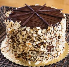 a cake with chocolate frosting and nuts on top