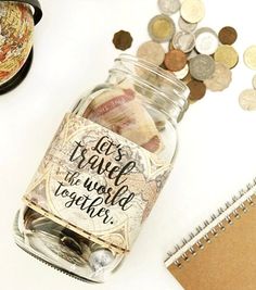 a jar filled with coins next to a notebook