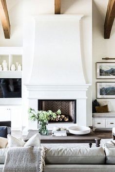 a living room filled with furniture and a fire place in the middle of a room