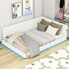 a bed sitting on top of a hard wood floor