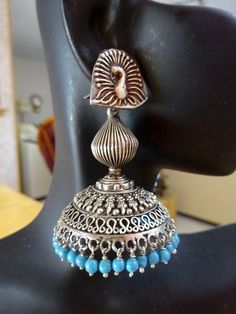 "These are an exquisite pair of jhumkas very ornate and the peacock posts add elegance! Blue beads complement very well! Let me know if you want all silver beads or differnt crystals- happy to customize. All custom requests will be extra! These jhumkas are on the large side but not heavy at all! These are famous in Jaipur, Rajasthan and all over India, wear this with a tunic top on jeans or shorts, simply out of this world. Wear these to your favorite Indian Restaurant Total length from top of the ear wire 2.5\".  WIdth-1.8\". Metal - oxidized Sterling Silver. Please feel free to ask me for more pictures or questions. Thank You for Shopping Jhumkas they are Ancient, Elegant, Opulent and Regal!" Blue Bohemian Jhumkas For Festive Occasions, Festive Blue Bohemian Jhumkas, Festive Bohemian Blue Jhumkas, Temple Jewelry Peacock Design Chandbali Jhumkas, Temple Jewelry Chandbali Jhumkas With Peacock Design, Navratri Temple Jewelry Jhumkas With Peacock Design, Temple Jewelry Jhumkas With Peacock Design For Navratri, Silver Chandbalis With Peacock Design For Festivals, Traditional Peacock Design Jhumkas For Festive Occasions