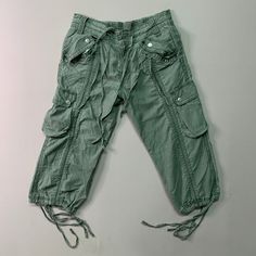 [DESCRIPTION] Please read the description first before buy my items‼️‼️‼️ Vtg Unbranded Utility Multipocket Tactical Cropped Pants All in good condition [MATERIAL] Cutton [MEASUREMENT] Measurement ( WHEN LAID FLAT ): Waist: 29-31 inch (recommended) Insean: 18.5 inch Length: 26 inch Front Rise: 9.5 inch Thigh: 19 inch Opening Leg: 16 inch [CONDITION] - All in good condition  - No hole no stain [PAYMENT & NOTICE] - We accept PayPal ONLY - No return/refund - All items will be post over shipping com Military Style Green Cargo Jeans With Hip Pockets, Green Military Cargo Jeans With Hip Pockets, Green Combat Bottoms With Pockets, Cotton Combat Cargo Shorts, Green Combat Style Parachute Pants With Pockets, Green Combat Parachute Pants With Pockets, Green Combat Cargo Pants With Pockets, Green Military Cargo Shorts With Pockets, Pants Vintage